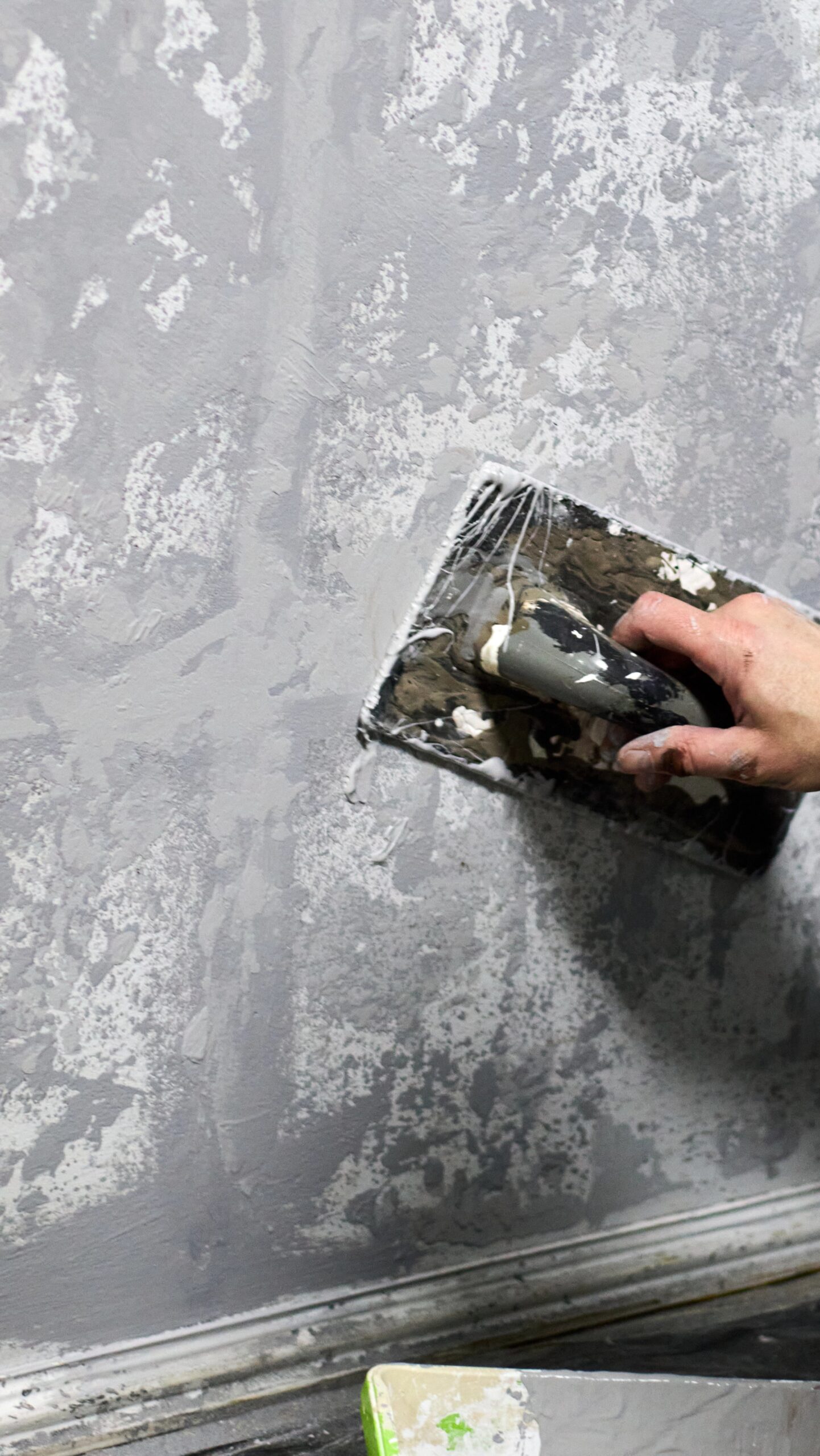 Plaster being applied to a wall by hand